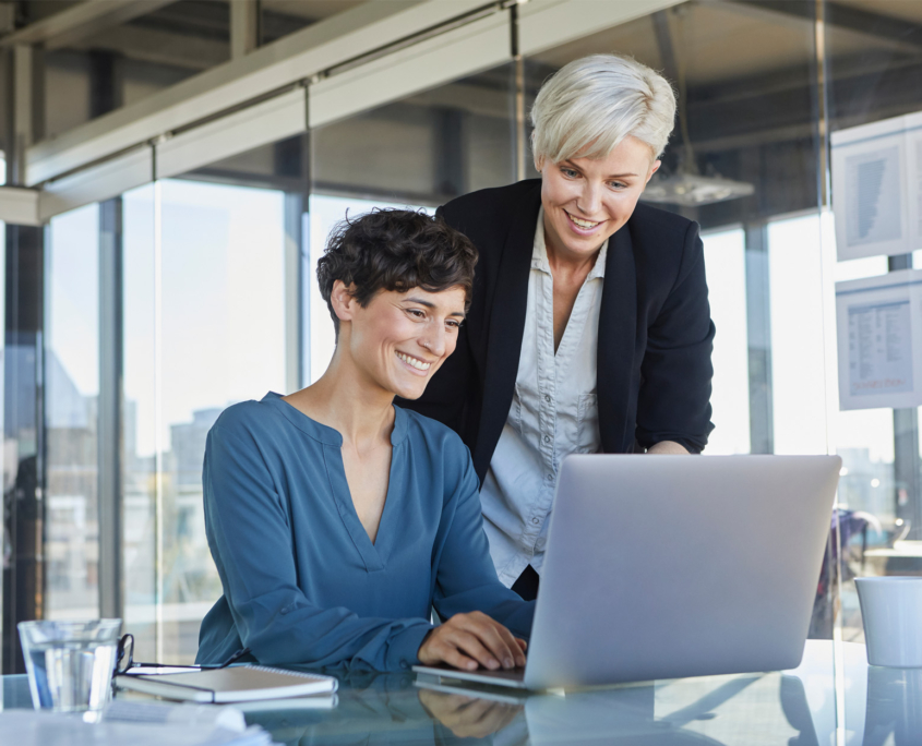 2 team members in office at computer