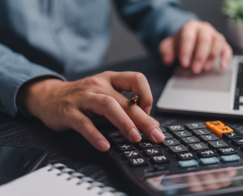 Businessman using calculator bookkeeping payroll and budget tax