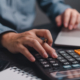 Businessman using calculator bookkeeping payroll and budget tax